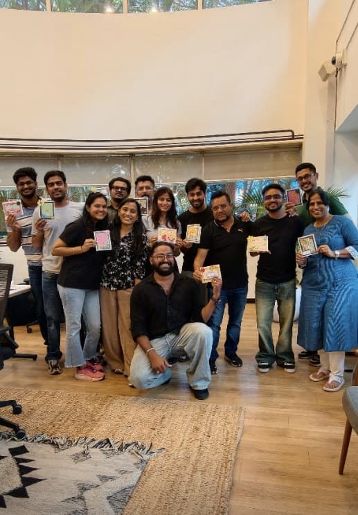 A corporate team holding the pieces they made in a workshop